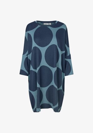 Niebiesko-zielony, oversize'owy top z rękawami 3/4, ozdobiony dużymi okrągłymi wzorami i okrągłym dekoltem. Miękka tekstura materiału.