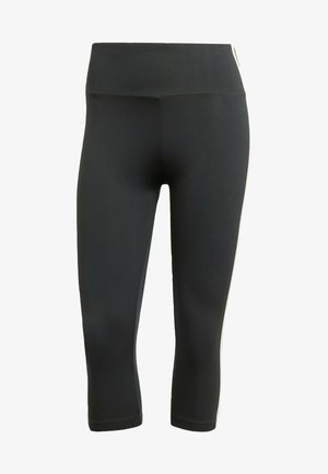 Svarte capri leggings laget av stretchy materiale, med en bred midje og hvite side-striper for kontrast og detaljer.