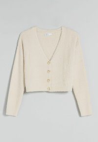 Krátký krémový kardigan z texturované tkaniny, s výstřihem do V a pěti béžovými knoflíky vpředu. Dlouhé rukávy.