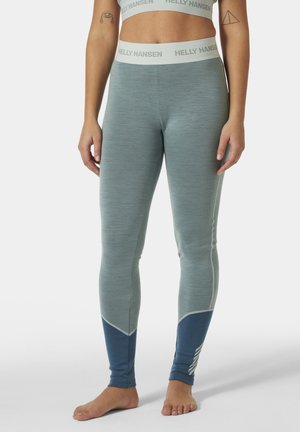 Lichtblauwe leggings met een gestructureerde afwerking en contrasterende donkerblauwe accenten. Voorzien van een merkband en een chevronpatroon bij de enkels.