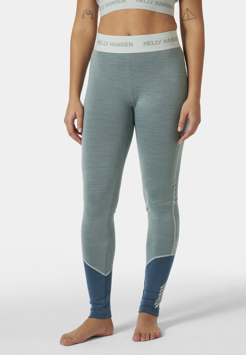 Leggings azul claro con acabado texturizado y acentos en azul oscuro. Presentan una cinturilla con marca y un patrón de flecha en los tobillos.