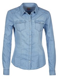 Light blue denim shirt with long sleeves, button-up front, two chest pockets, and a pointed collar. Features a fitted design and soft texture.
