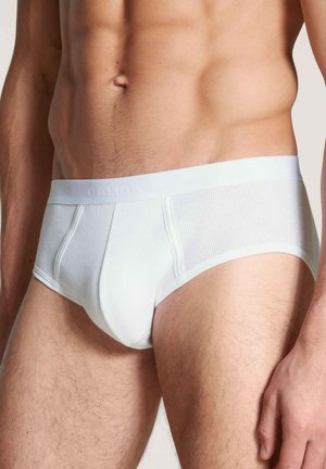 Witte katoenen slip met ribbelstructuur, elastische tailleband met merknaam en een aansluitend ontwerp dat minimale bedekking biedt.