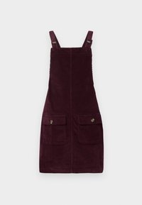 Robe en velours côtelé de couleur bourgogne profond, avec des bretelles ajustables, des poches avant avec quincaillerie en métal et une coupe ajustée. Tissu texturé.