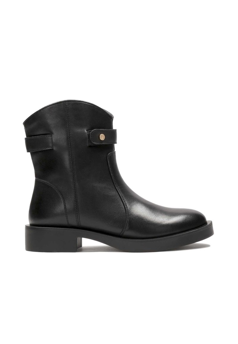 Black leather ankle boot with a rounded toe, flat sole, side buckle detail, and smooth texture. Features a seam at the back and a circular accent.