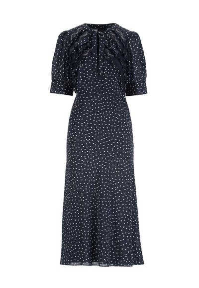 Marineblaues Kleid mit weißen Punkten, Puffärmeln, gerüschten Details vorne und gebundenem Ausschnitt. Hergestellt aus leichtem Stoff mit fließendem Design.