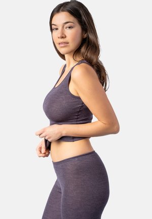 Purple ribbed crop top paired with matching high-waisted leggings. Soft texture and fitted design, with wide shoulder straps and a midriff cut.