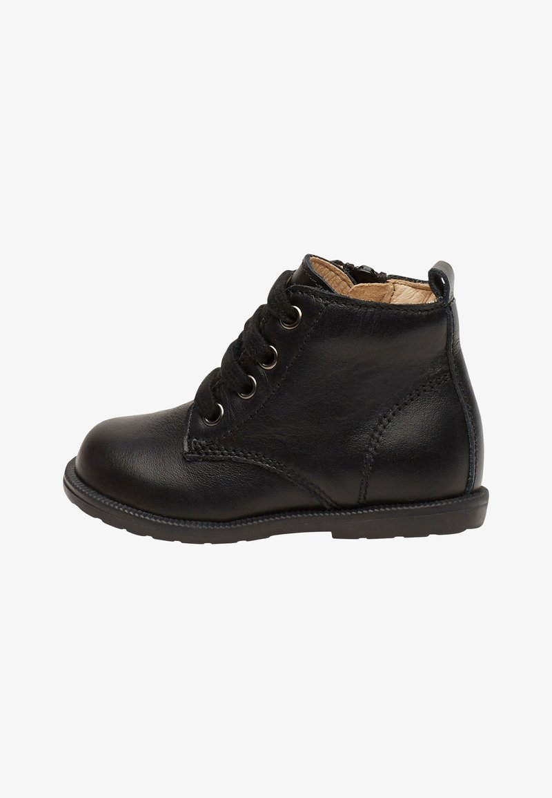 Botín de cuero negro hasta el tobillo con punta redonda, cierre de cordones en la parte delantera y superficie texturizada. Presenta detalles de costura y una suela de goma con un dibujo mínimo.