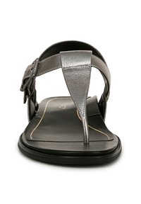 Metallic gray leather thong sandal with a flat black sole, featuring a toe post and ankle strap with adjustable buckle hardware.