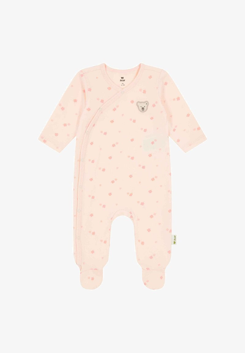 Grenouillère pour bébé rose pâle avec manches longues, jambes couvertes, petits imprimés de fleurs roses, boutons-pression et un patch en forme de visage d'ours en peluche sur la poitrine.