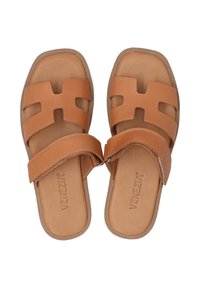 Braune Leder-Sandalen mit Riemen, die ein Ausschnittdesign und eine gepolsterte Innensohle aufweisen. Die Laufsohle ist strukturiert für besseren Grip und hebt sich durch kontrastierende Nähte ab.