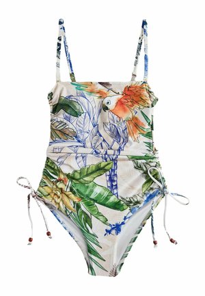 Swimsuit with thin straps, adjustable side ties, tropical print featuring green leaves, yellow flowers, and an orange parrot on a light background.