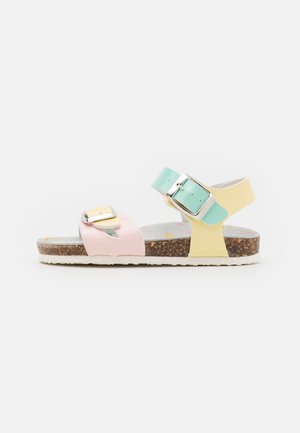 Colorful sandals featuring pink, mint, and yellow straps, adjustable buckles, a cork footbed, and a textured sole for grip.