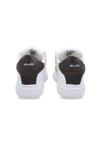 White and brown sneaker with a textured back, padded collar, and logo details. Features a solid rubber sole and minimalistic design.