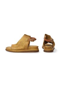 Leather open-toe sandals in a soft mustard color with a low heel and adjustable buckle strap. Features a textured finish and minimalist design.