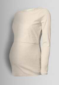 Cămașă de maternitate bej deschis, cu mâneci lungi și design ajustat, cu accente pe panourile laterale, creată pentru confort în timpul sarcinii.