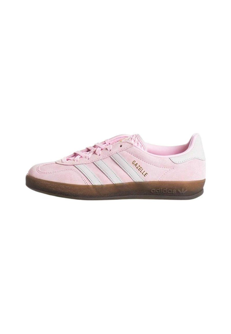 Pink suede sneaker with three white stripes, textured brown rubber sole, and "GAZELLE" branding. Low profile design with lace closure.