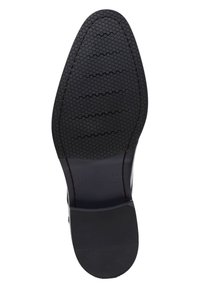 Suola di scarpa nera in gomma con un motivo a rilievo esagonale, caratterizzata da un bordo liscio e testo stampato che indica il marchio e il modello.