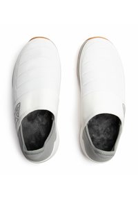 Scarpe bianche senza lacci con tomaia trapuntata, accentate da grigio, foderate in morbido tessuto e suola in gomma. Presentano un logo sul lato.