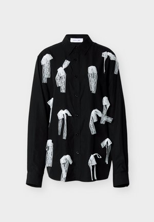 Μαύρο πουκάμισο με κουμπιά και άσπρες δαντέλες που μοιάζουν με φιόγκους, με μυτερό γιακά και  μακριά μανίκια. Λείο ύφασμα.