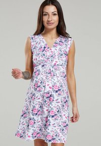 Floral dress with a v-neck, sleeveless design. Features a white background with pink and blue flower patterns, slightly flared hem.