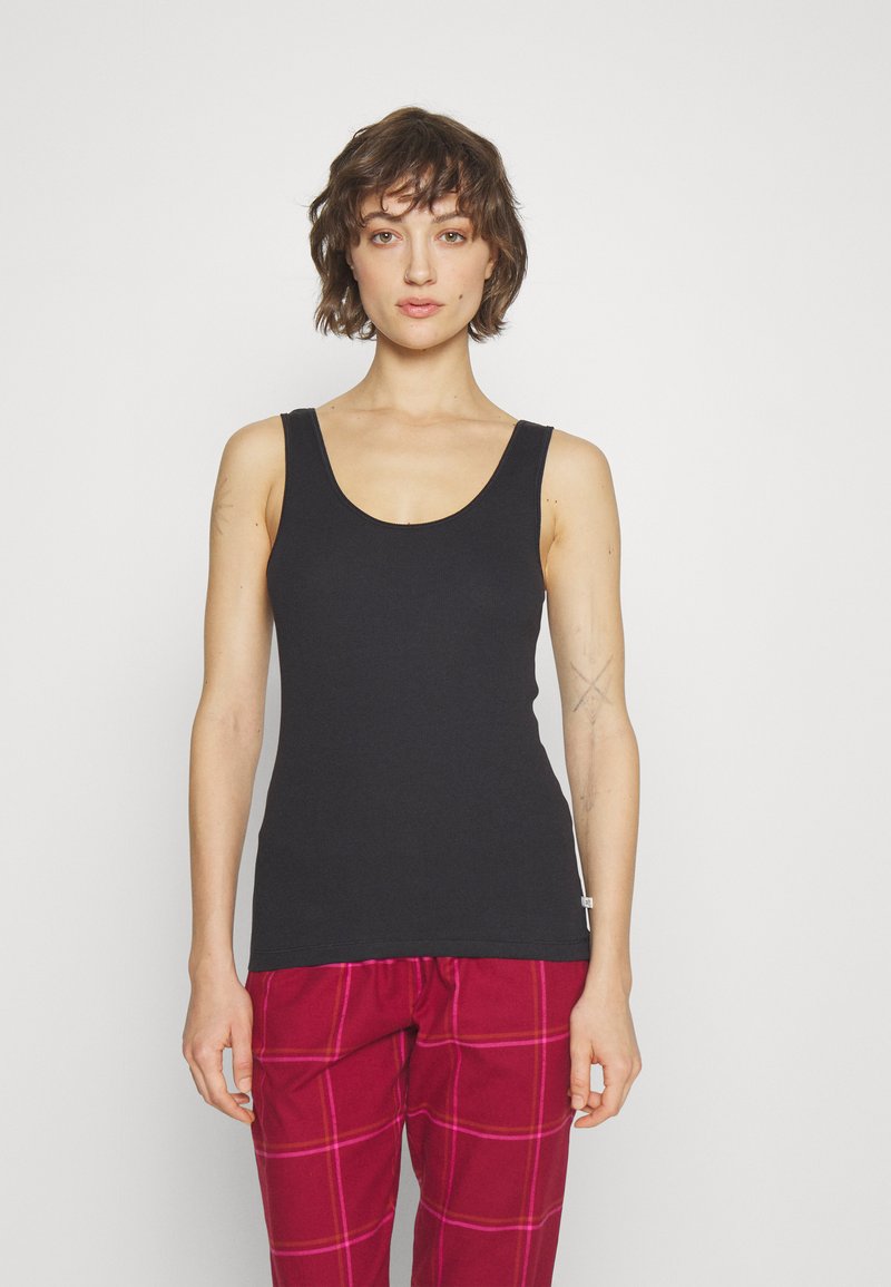 Svart ermeløs tanktop laget av mykt stoff, med rund hals og sømløse kanter for en jevn passform. Ingen synlige logoer eller mønstre.