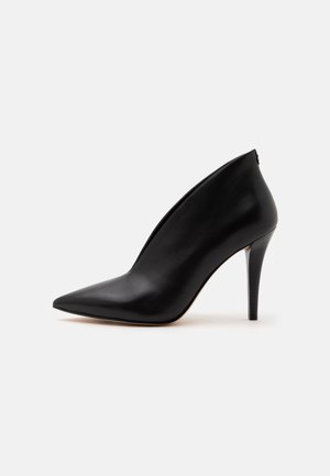 Black leather pointed-toe high heel shoe with a deep V-cut upper and slender stiletto heel on a white background.