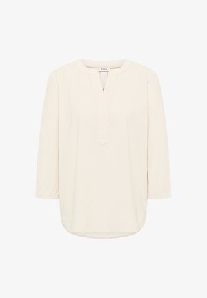 Blouse crème à manches longues avec un col rond, une fente en V et une coupe ample et décontractée.