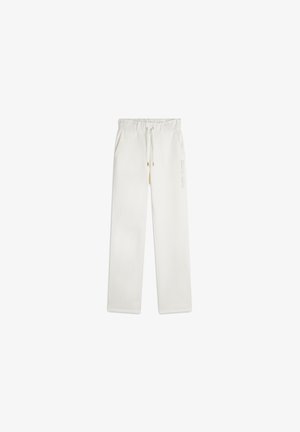Pantaloni jogger bianchi con vita elastica e cordoncino, due tasche laterali e un branding discreto sulla gamba sinistra.