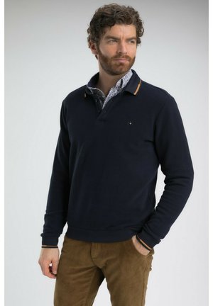 Polo à manches longues bleu marine en tissu doux, avec un col intérieur à motifs contrastants et des accents rayés sur les poignets. Design décontracté.