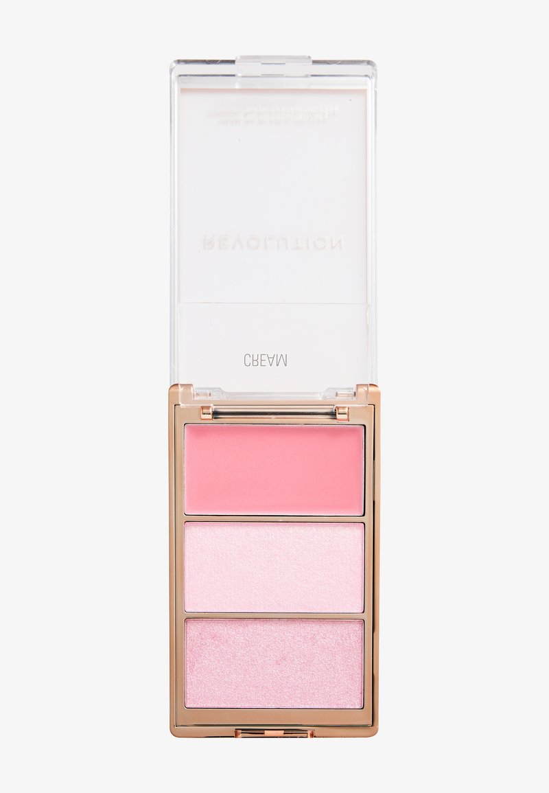 Palette de maquillage rectangulaire avec trois teintes de blush crème ou fard à paupières rose, dans un boîtier bordé d'or avec un couvercle transparent à charnière.