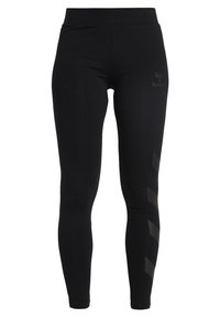 Leggings neri realizzati in tessuto elasticizzato, caratterizzati da una vita ampia e una stampa logo sottile. Accentuati da motivi geometrici neri sui lati.