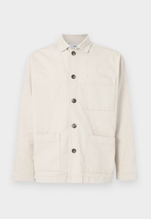 Beige cotton jacket with a collar, front button closure, two large front pockets, and a single chest pocket. Textured fabric with a plain design.