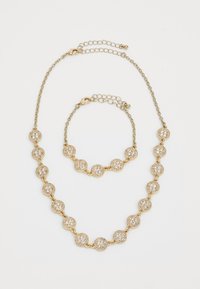 Gold-tone necklace and bracelet featuring round, crystal-encrusted charms linked by delicate chains with adjustable clasps.
