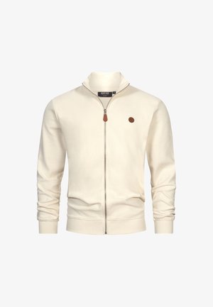 Kremowa kurtka zapinana na zamek, wykonana z materiału w prążki. Posiada stojący kołnierz, slim fit oraz małe, okrągłe brązowe logo na piersi.