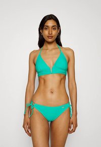 Turkizen modro zelen modrček v obliki trikotnika z nastavljivimi trakovi za okoli vratu, združen z ujemajočim se hlačnim delom v stilu hipstera, ki ima bočne trakove in subtilen logotip.