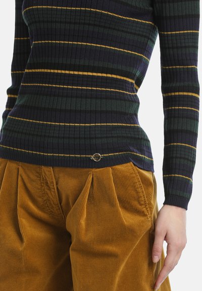 Top a maniche lunghe a maglia rigata in verde scuro e blu navy con strisce gialle; abbinato a pantaloni in corduroy a pieghe color senape. Piccolo logo all'orlo.