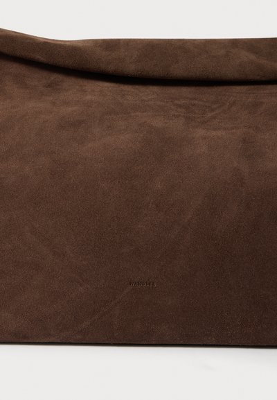 Brūna zamšādas pastnieka soma ar gludu tekstūru, pārmērīga izmēra aizsegu un reljefu ar uzveltā logotipa detaļu, ar minimālistisku dizainu un nomierinošu krāsu.