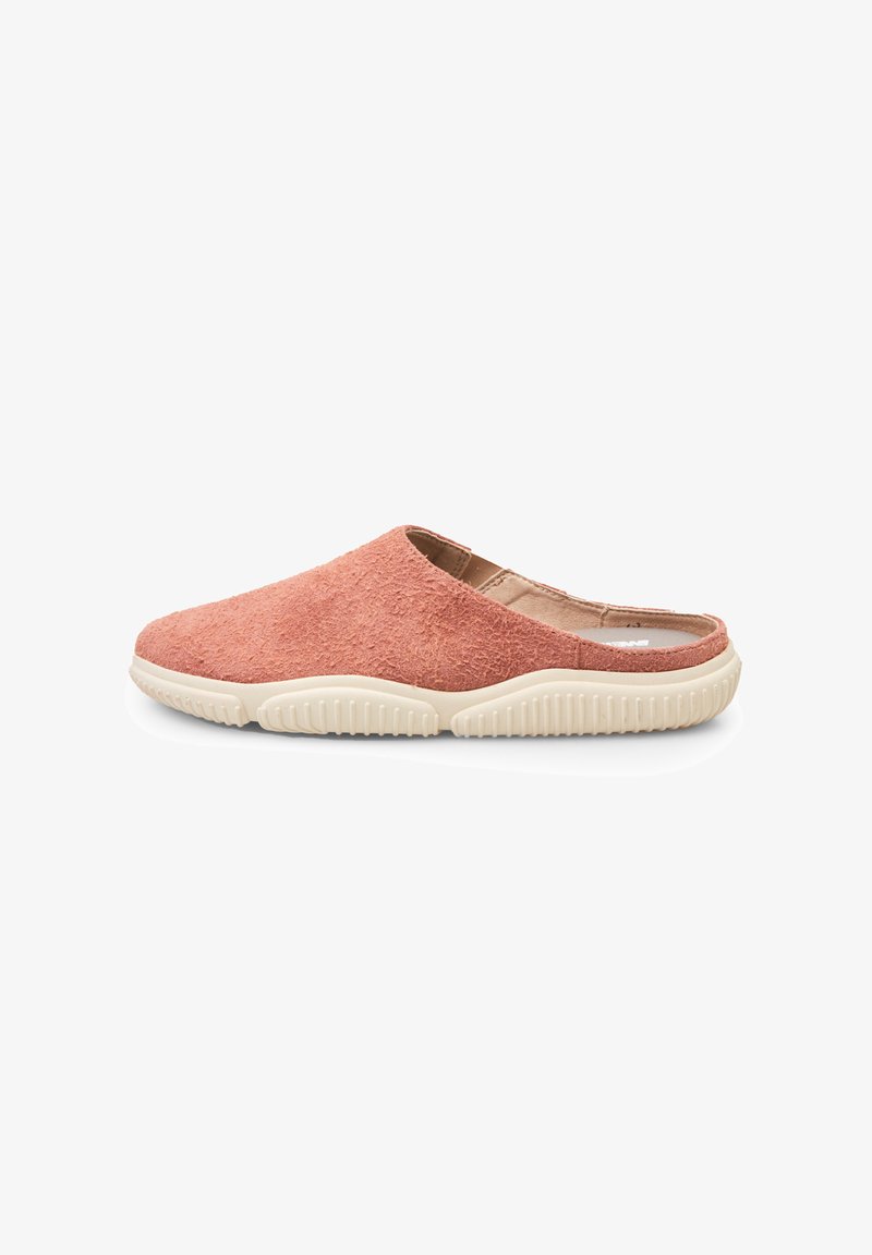 Pink slip-on slippers featuring a textured upper and a cream rubber sole with ridged traction for grip. Lightweight and seamless design.
