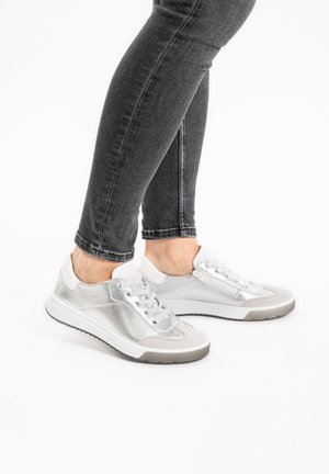 Silver athletic shoes with a textured metallic finish, white accents, and a light gray sole. Laces and side zippers visible.