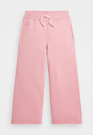 Pantaloni sportivi rosa chiaro con vita a coulisse, due tasche laterali e un piccolo logo sul lato sinistro anteriore. Tessuto morbido e testurizzato.