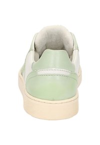 Green and white leather sneaker featuring a textured back, padded collar, and rubber sole with horizontal lines for grip.