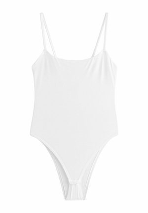 Maillot de bain une pièce blanc avec fines bretelles et encolure droite, présentant des ouvertures de jambes échancrées.