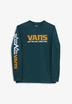 Chemise en coton bleu à manches longues avec logo "VANS" blanc et doré ainsi que texte, ornée d'un motif géométrique sur la manche gauche. Col rond classique.