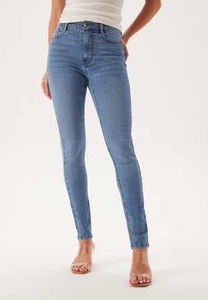 Lichtblauwe skinny jeans van denim met een hoge taille, voorzien van een klassieke vijf-pocket ontwerp en subtiele vervaagde details.