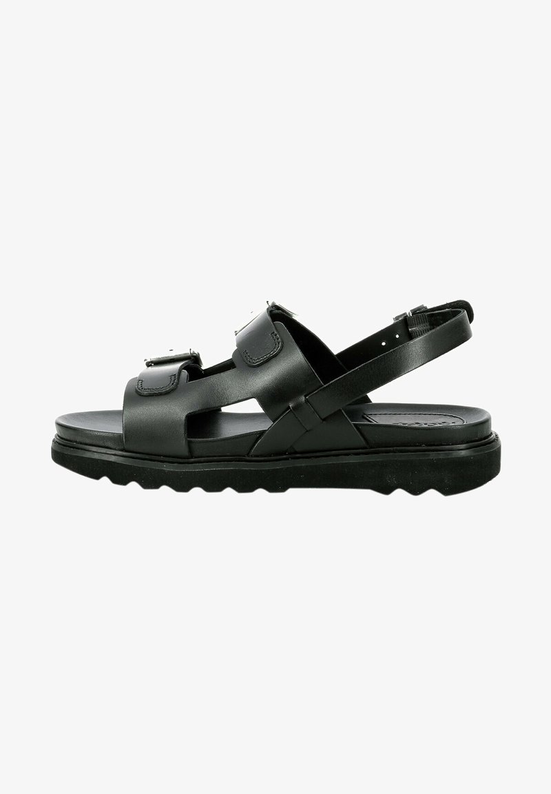 Zwarte leren sandalen met verstelbare banden, een platte zool met structuur voor grip, en een minimalistisch ontwerp met uitsnijdingen.