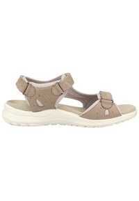 Sandal beige à multiples lanières en matériau suédé doux, avec une semelle blanche rembourrée, des fermetures à crochets et boucles réglables, et des découpes pour une meilleure circulation de l'air.