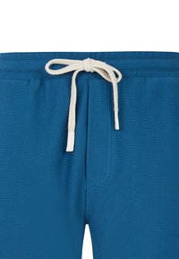Blå teksturerede loungbukser med elastisk talje og cremefarvet snor, der har et geometrisk mønster og sidelommer.
