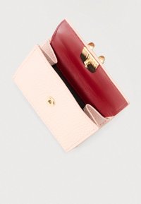 Δερμάτινο πορτοφόλι σε ροζ και κόκκινο χρώμα, με υφή στην εξωτερική πλευρά, λείο εσωτερικό και κούμπωμα σε χρυσό τόνο. Κλειστό σχέδιο, συμπαγής μορφή.