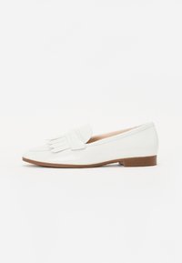 White patent leather loafer with fringe detail on the upper, rounded toe, and a low brown block heel. Smooth texture and minimalist design.